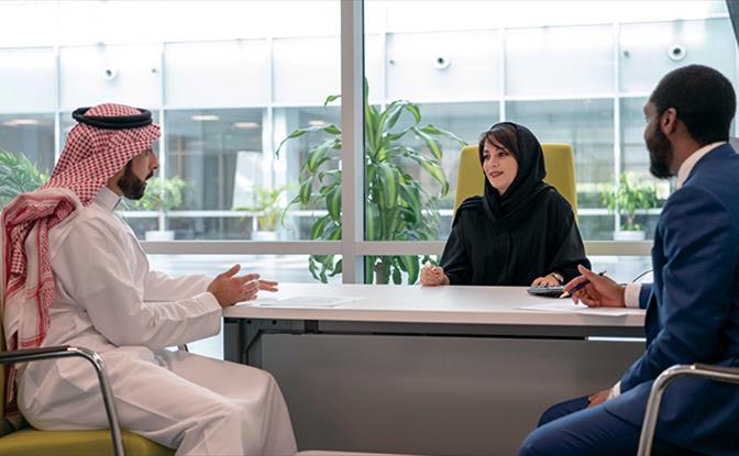 Three people in a meeting