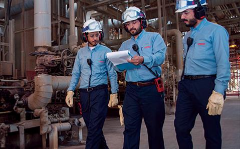 Three workers in a plant