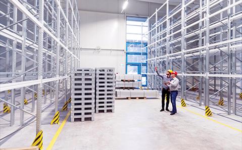 two businessmen meeting in a warehouse