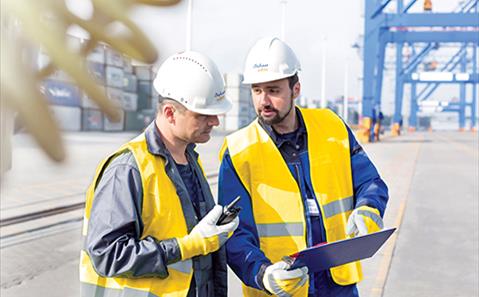 workers talking at container port