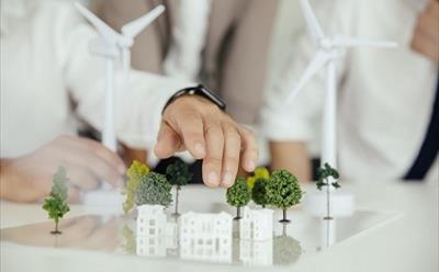 Close-up of business people wind turbine model