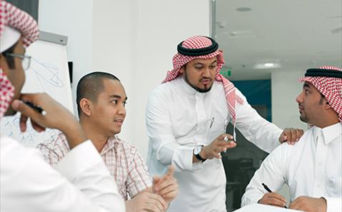 business employees talking at SABIC Academy