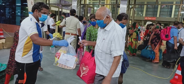 Handing over food packages to beneficiaries