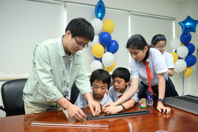 Students learning color sorting with SABIC employee volunteers