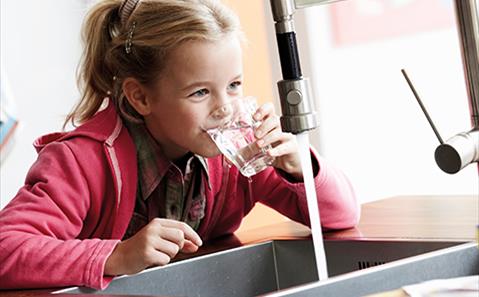 young girl drinking water