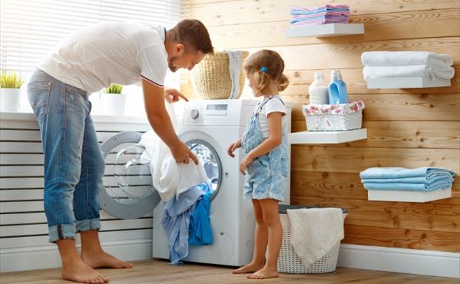 Father with child and washing machine