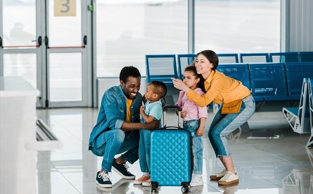 Smiling african american family with kids in airport Smiling african american family with kids in airport