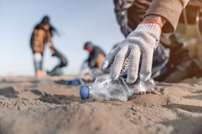 Volunteer collecting trash on the beach