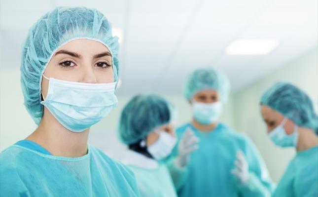 Young femal surgeon with medical team Young femal surgeon with medical team